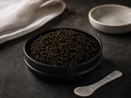 Ossetra caviar tin on dark slate with mother-of-pearl spoon