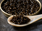 Ossetra caviar pearls close-up macro on mother-of-pearl spoon