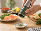 Premium Korean gamtae sea salt grinder on bright wooden table with salt being ground onto ceramic dish, natural daylight