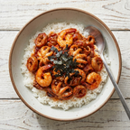Nakgopdaesae served over steamed rice with seaweed garnish