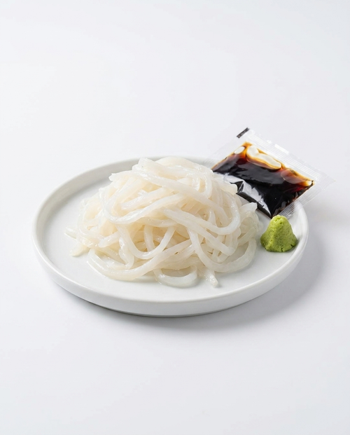 Ika Slice cuttlefish noodles plated with soy sauce and wasabi